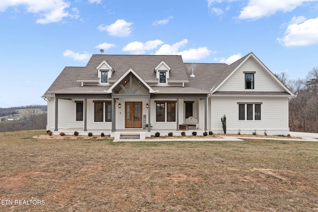 view of front of property with a front yard and covered porch