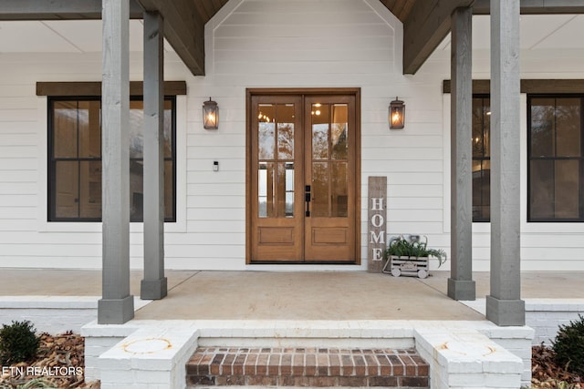 entrance to property featuring french doors and a porch