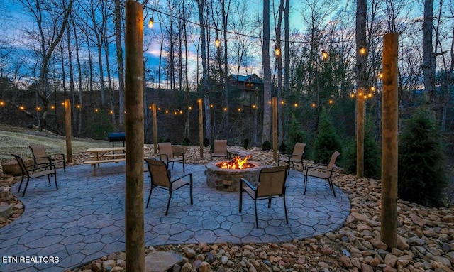 patio terrace at dusk with a fire pit