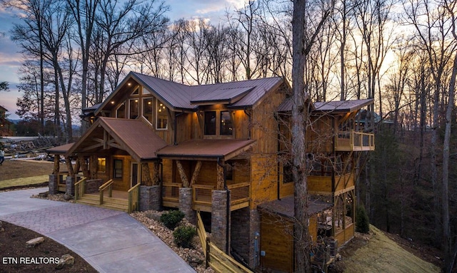 view of front of house featuring covered porch and a balcony