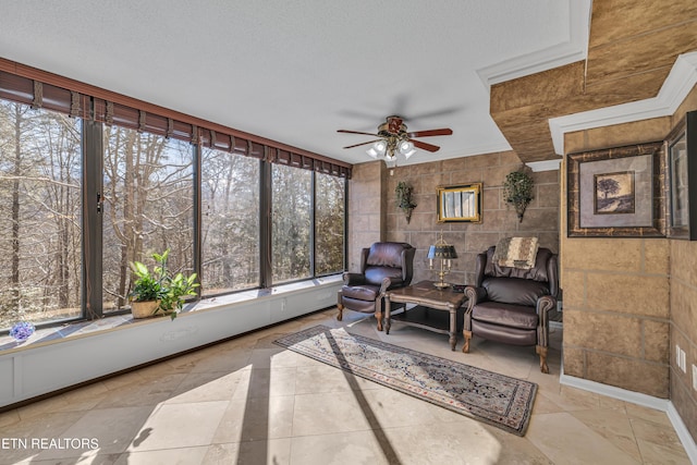 sunroom featuring ceiling fan