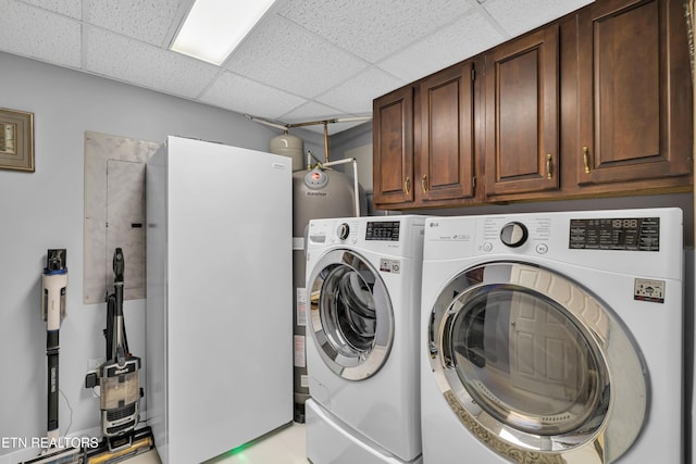 washroom with cabinets and washing machine and dryer