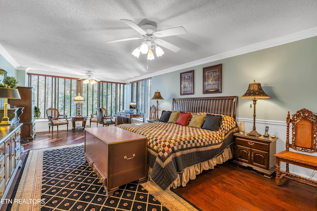 bedroom featuring a textured ceiling, ornamental molding, dark hardwood / wood-style floors, and ceiling fan