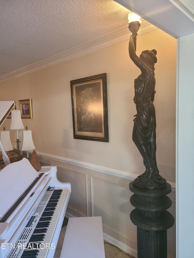 details with a wainscoted wall, crown molding, and a textured ceiling