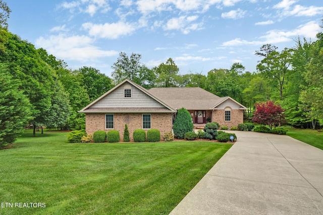 56 Westridge Ct, Fairfield Glade, TN 38558 - view of front facade featuring a front lawn, brick siding, and concrete driveway