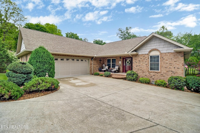 56 Westridge Ct, Fairfield Glade, TN 38558 - single story home featuring covered porch, brick siding, an attached garage, concrete driveway, and a shingled roof
