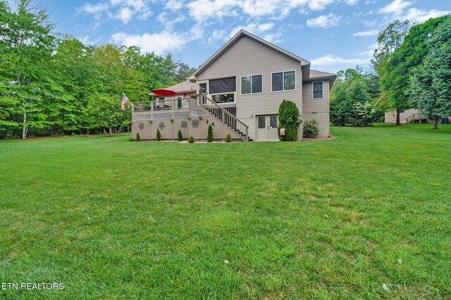 56 Westridge Ct, Fairfield Glade, TN 38558 - rear view of house featuring a lawn, stairway, a deck, and a sunroom