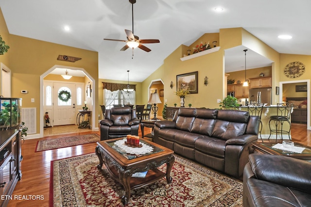 56 Westridge Ct, Fairfield Glade, TN 38558 - living area with vaulted ceiling, a ceiling fan, wood finished floors, and arched walkways