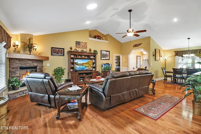 56 Westridge Ct, Fairfield Glade, TN 38558 - living room featuring vaulted ceiling, a fireplace, ceiling fan, wood finished floors, and arched walkways