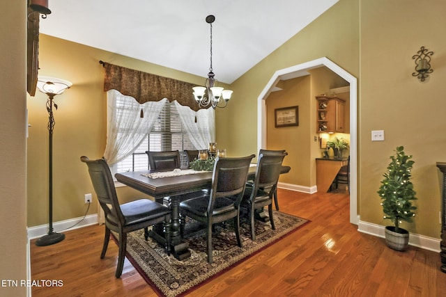 56 Westridge Ct, Fairfield Glade, TN 38558 - dining space with a chandelier, wood finished floors, arched walkways, baseboards, and lofted ceiling