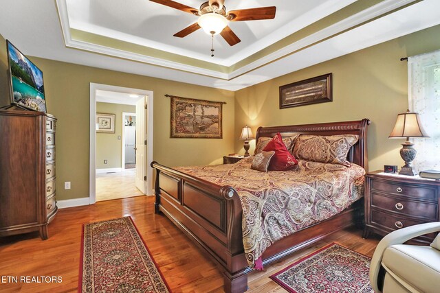 56 Westridge Ct, Fairfield Glade, TN 38558 - bedroom featuring wood finished floors, a tray ceiling, and ceiling fan