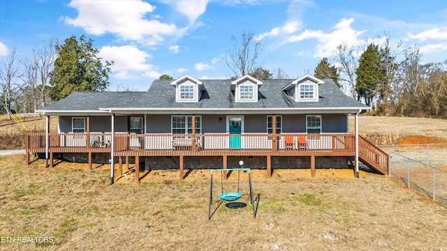 view of front of property with a front yard and a wooden deck