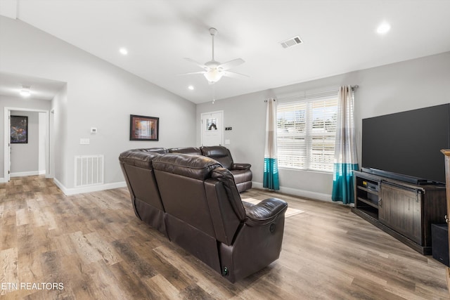 living room featuring ceiling fan, vaulted ceiling, and hardwood / wood-style floors