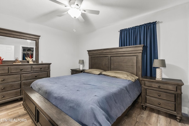 bedroom with ceiling fan and hardwood / wood-style flooring