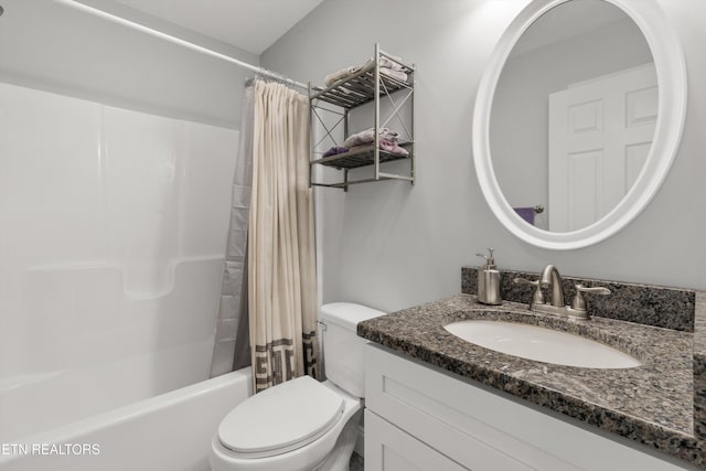 full bathroom featuring toilet, vanity, and shower / tub combo with curtain