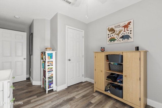 unfurnished bedroom with ceiling fan and dark hardwood / wood-style floors