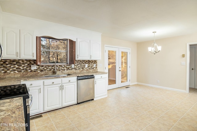 kitchen with decorative backsplash, white cabinets, hanging light fixtures, and appliances with stainless steel finishes