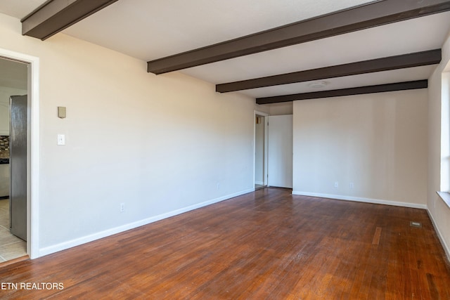 unfurnished room featuring beam ceiling and dark wood-type flooring