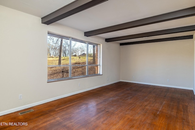 spare room with dark hardwood / wood-style floors and beamed ceiling