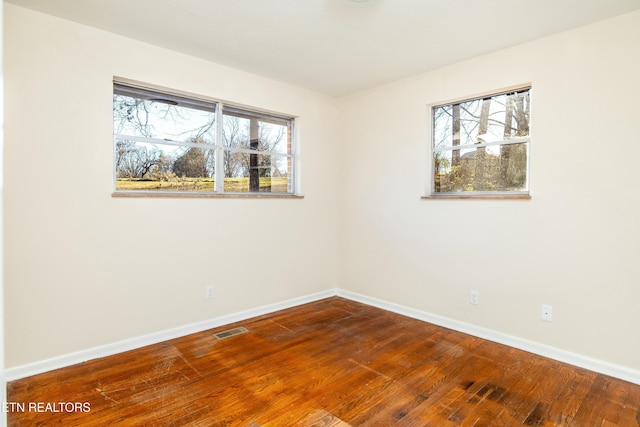 unfurnished room featuring hardwood / wood-style floors