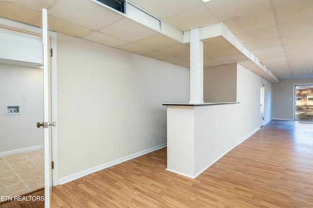 interior space with hardwood / wood-style floors and a drop ceiling