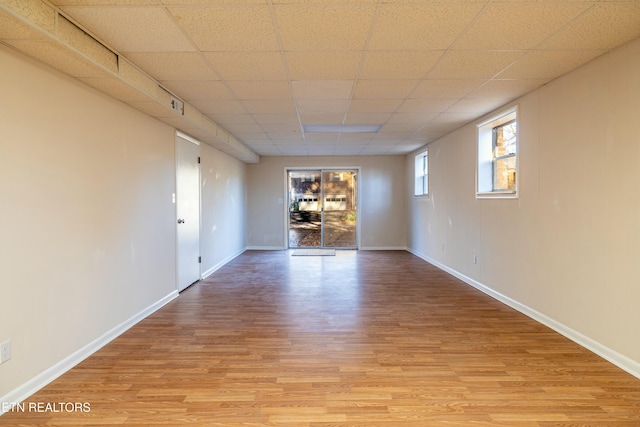 unfurnished room featuring a paneled ceiling and light hardwood / wood-style floors