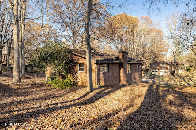 back of house featuring a garage and an outdoor structure