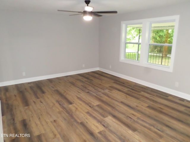 empty room with dark wood-type flooring and ceiling fan