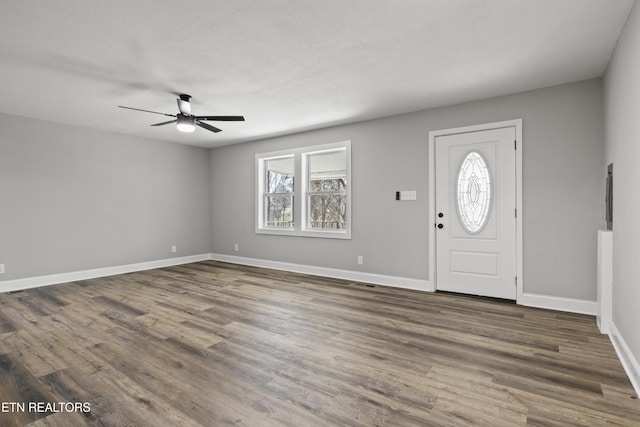 entryway featuring wood finished floors, a ceiling fan, and baseboards