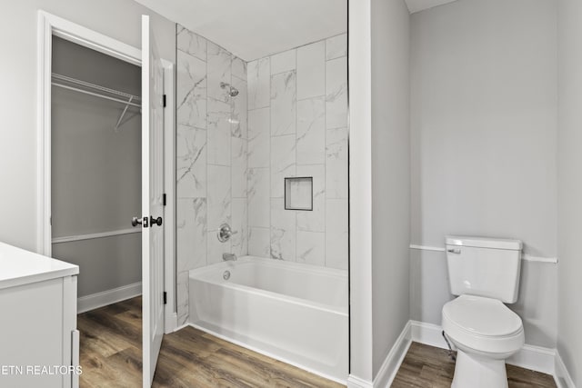 full bathroom featuring baseboards, shower / bathing tub combination, toilet, and wood finished floors