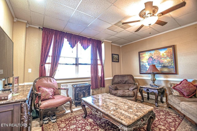 living room featuring crown molding and ceiling fan