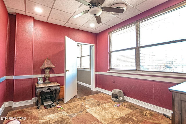 miscellaneous room with a paneled ceiling and ceiling fan