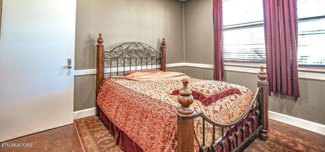 bedroom with dark wood-type flooring