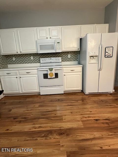 kitchen with backsplash, white cabinetry, white appliances, and dark hardwood / wood-style floors