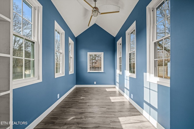 spare room with vaulted ceiling, hardwood / wood-style floors, and ceiling fan