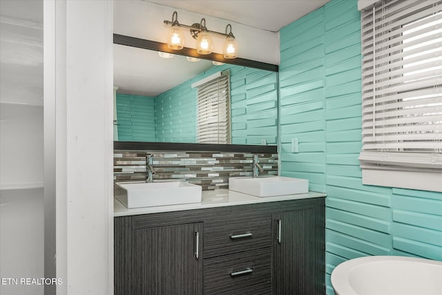 bathroom featuring tasteful backsplash, vanity, and a washtub