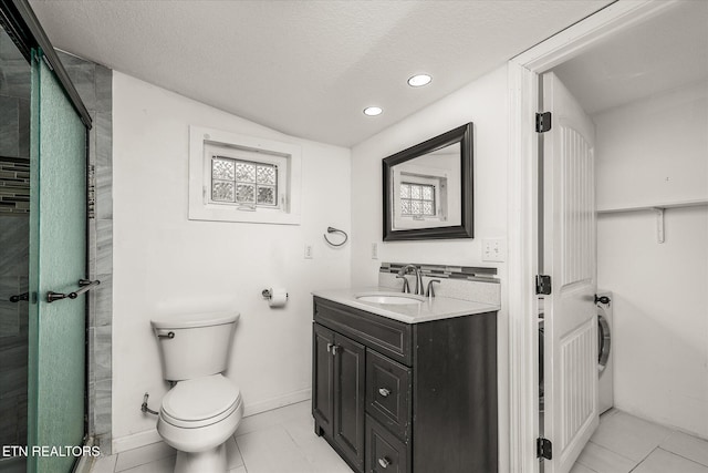 bathroom featuring washer / clothes dryer, vanity, an enclosed shower, toilet, and a textured ceiling