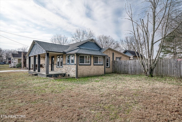 view of property exterior featuring a porch and a yard