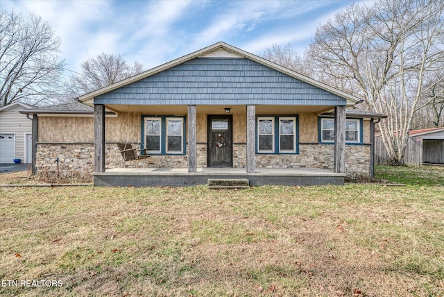 view of front of house featuring covered porch and a front lawn