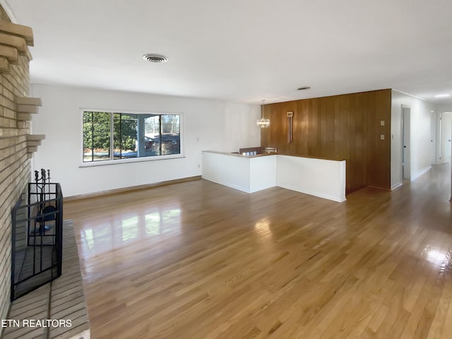 unfurnished living room with hardwood / wood-style flooring and a fireplace