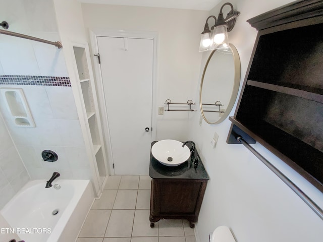 bathroom with tile patterned floors, vanity, and tiled shower / bath