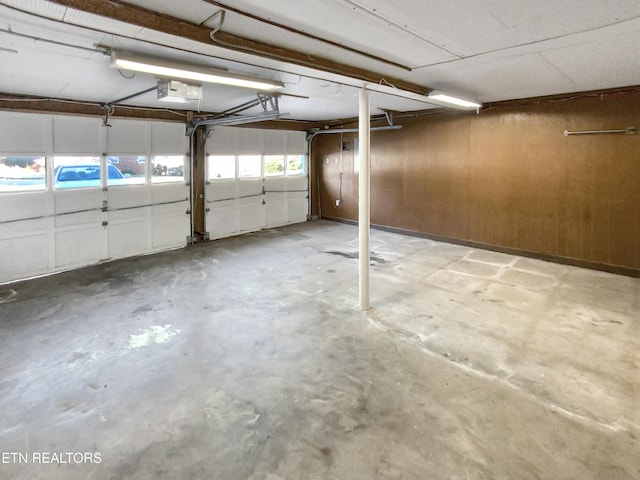 garage with wooden walls and a garage door opener