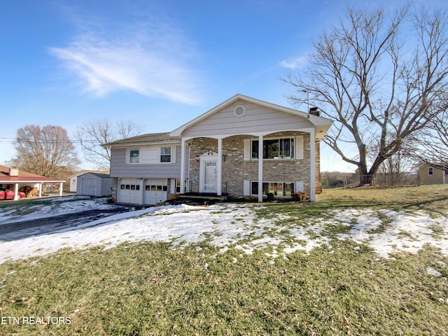 raised ranch with a garage, a front lawn, and a porch