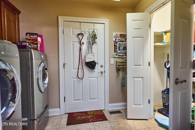 washroom with light tile patterned flooring and washer and clothes dryer