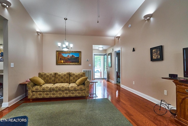 living room with hardwood / wood-style floors and a notable chandelier