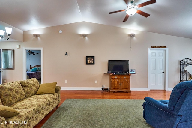 living room featuring ceiling fan, lofted ceiling, and hardwood / wood-style flooring