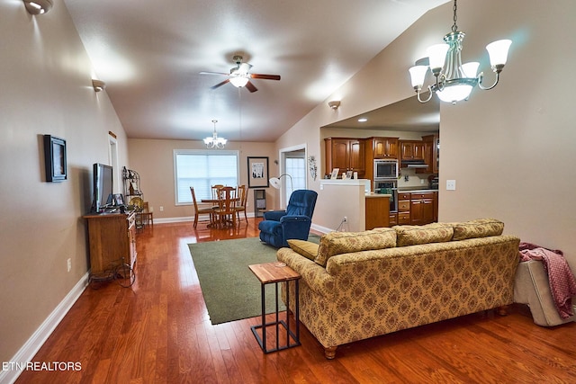 living room with vaulted ceiling, dark hardwood / wood-style floors, and ceiling fan with notable chandelier