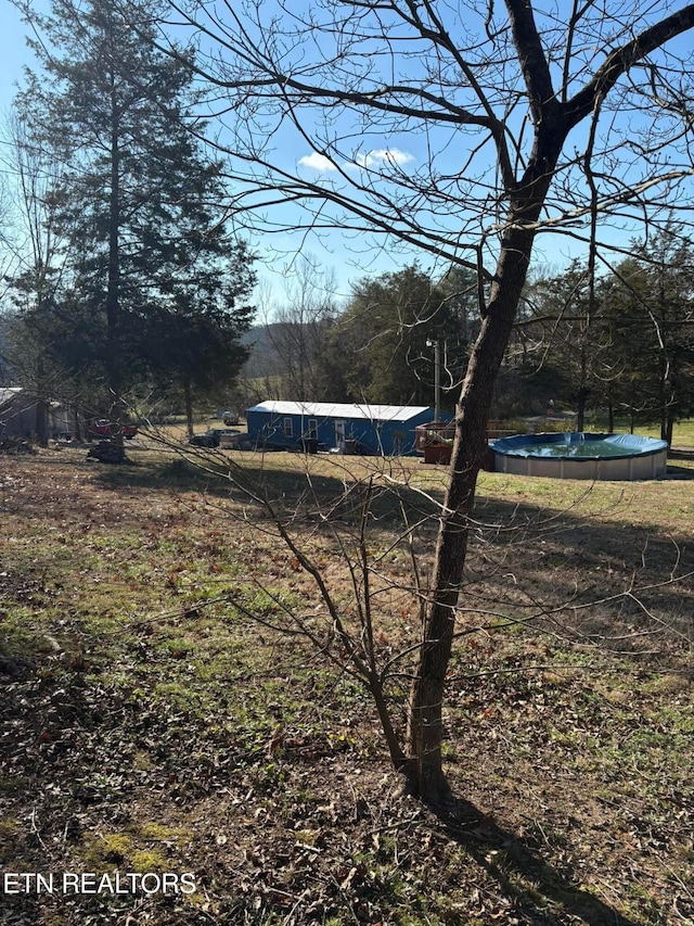 view of yard with a covered pool