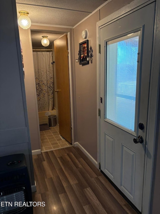 doorway to outside featuring dark hardwood / wood-style floors and crown molding