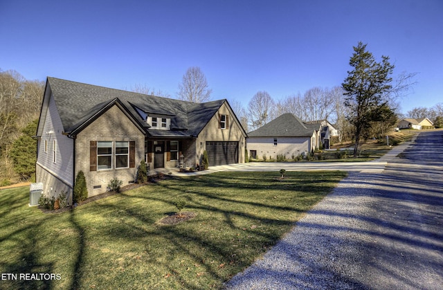 view of front of house featuring a garage and a front lawn